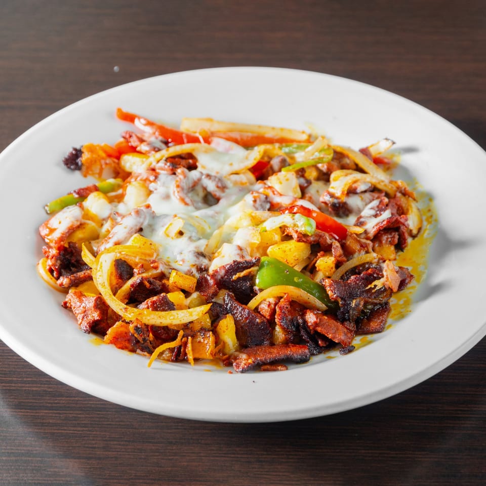 Meat with peppers, onions and melted cheese.