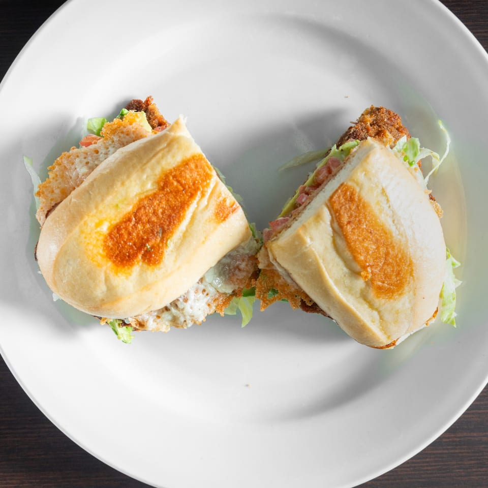 Two halves of a toasted Mexican torta.