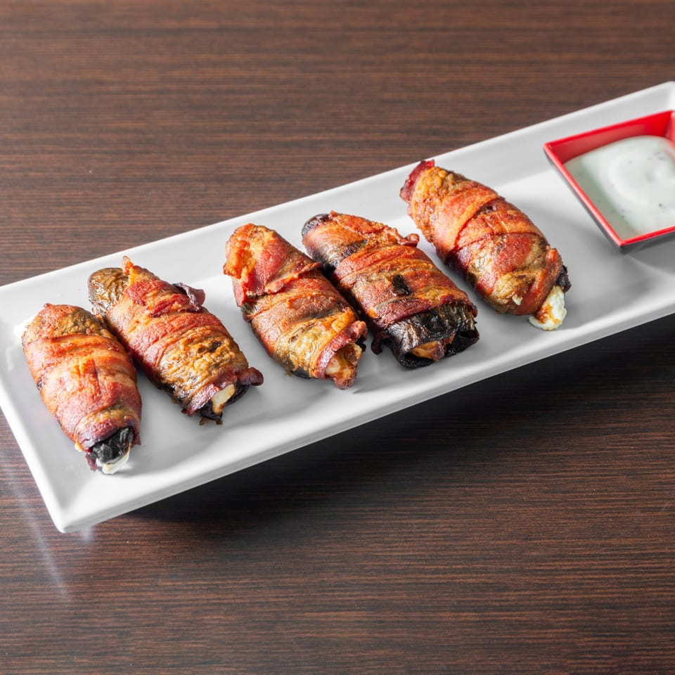 Bacon wrapped jalapenos with dipping sauce.