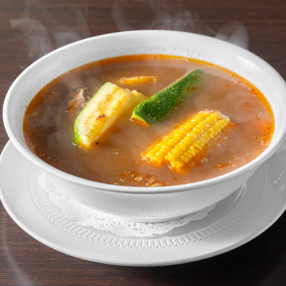 Soup with corn and zucchini.